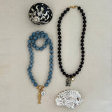 blue angelite and brown garnet beaded base necklaces with gold clasps, styled with pearl and gold charms