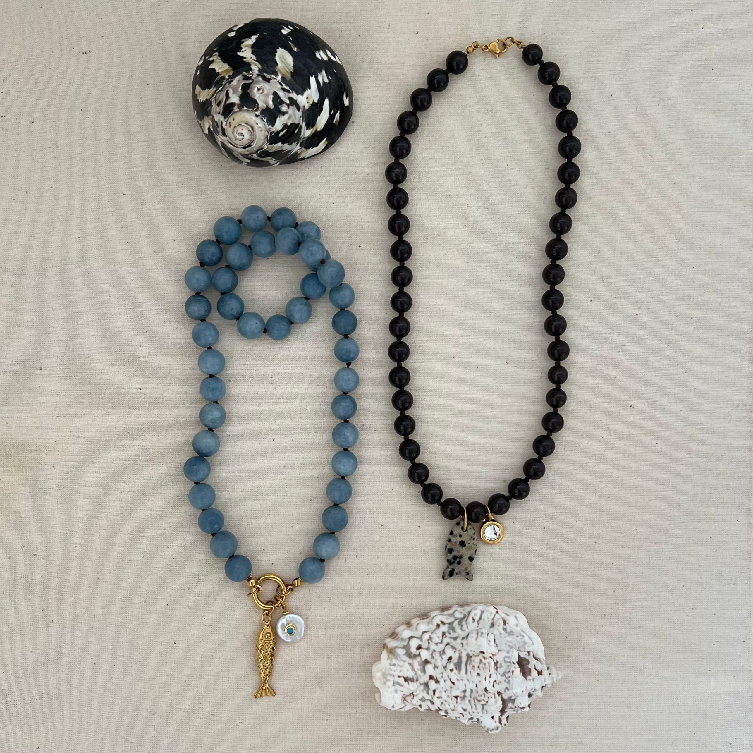 blue angelite and brown garnet beaded base necklaces with gold clasps, styled with pearl and gold charms